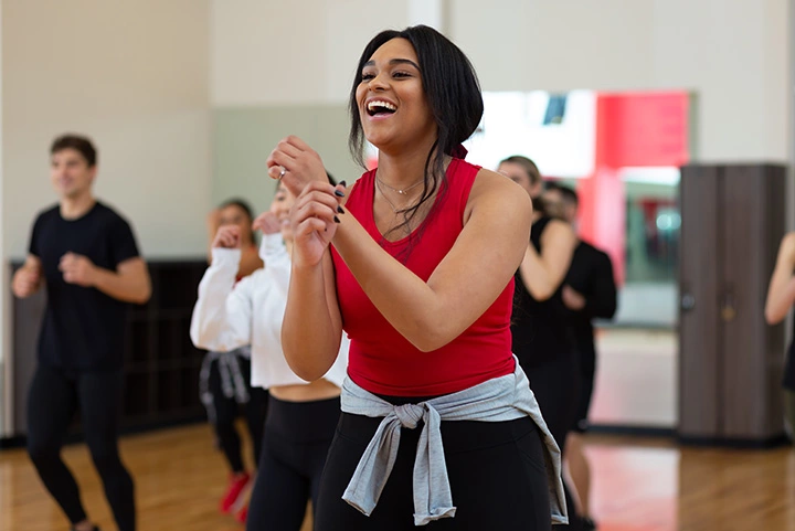 Laughing in a cardio group fitness class at a gym near you